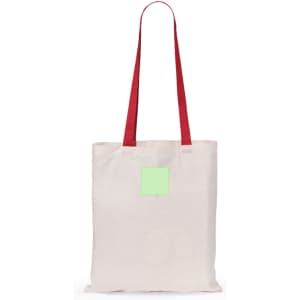 A tote bag in beige with red handles, featuring a rectangular patch in a light green shade.
