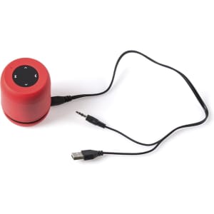 A red portable speaker with control buttons on top and connecting cables, including a USB and aux cable.