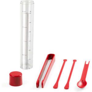 A clear drink bottle accompanied by red measuring tools, including a cap, tongs, and two stirrers.