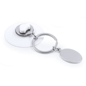 A silver keyring with a round disc and a clear backing, featuring a small attachment resembling a tooth.