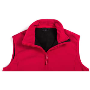 A red vest with a high collar and a front zip, featuring a black interior and a logo on the label.