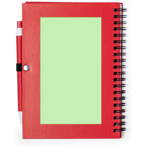 A red spiral-bound notebook with a green area on the cover and a pen attached.