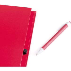 A red notebook with a pen resting beside it. The notebook features a binding and a logo.