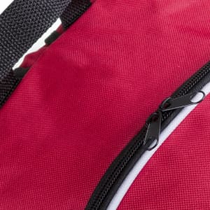 A red backpack featuring a black zipper and straps. The material has a textured appearance.