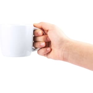 A white coffee mug held in a hand, featuring a simple design and a comfortable grip.