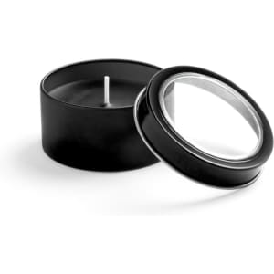 A black aromatic candle in a round tin with a clear lid, showcasing the candle's wick.