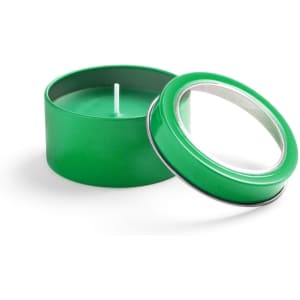 A green aromatic candle in a round tin with a removable lid. The candle is unlit and features a simple design.