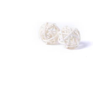 Two white decorative balls made of woven material, suitable for home décor.