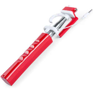 A red selfie stick with a metal extension pole and a coiled cable for phone connectivity. It features several buttons.