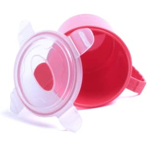 A pink jar with a clear lid sits upside down, showcasing its interior. The jar has a handle and a sleek design.