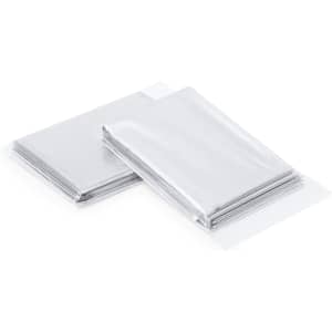 A stack of silver emergency space blankets in individual protective packaging, featuring a logo.