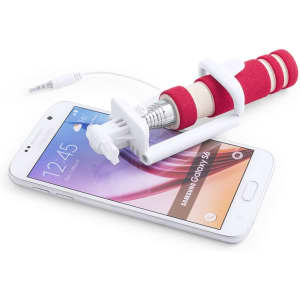 A red and white selfie stick attached to a smartphone, with a cable for connectivity. The phone displays a Samsung Galaxy interface.