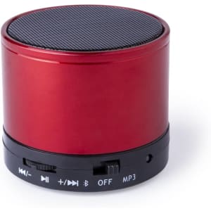 A red cylindrical speaker with a black mesh top and control buttons along the base. It features a logo on the side.