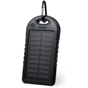 A black power bank with a textured surface and a carabiner for attachment. It features an indicator light and a logo.