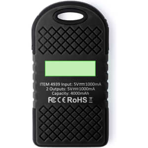 A black power bank with a textured surface, featuring a logo and specifications on one side.