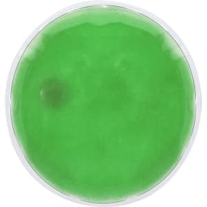 A round heat pack with a green gel inside, featuring a clear outer cover and a simple logo.