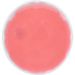 A round heat pack in a clear casing, filled with a pink gel substance.