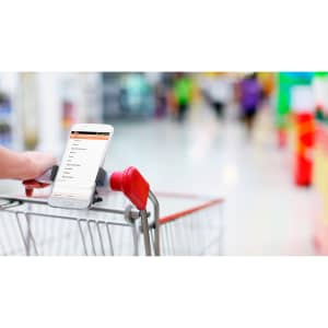 A car phone holder in black, securely attached to a shopping trolley, holding a smartphone with a visible screen.