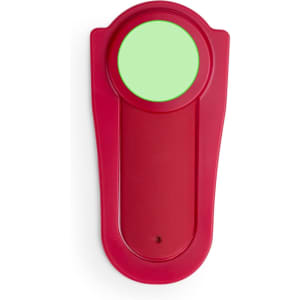 A red phone stand with a circular, green surface at the top and a smooth, curved base.
