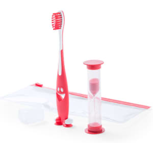 A pink toothbrush with a smiling face, a sand timer, and a clear zippered pouch.
