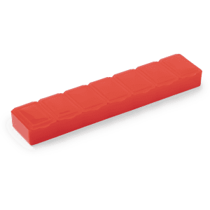 A red pillbox with seven compartments, designed for organising medications. It features a simple rectangular shape.