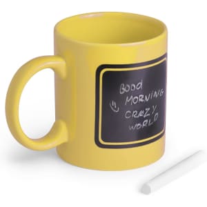 A yellow coffee mug with a chalkboard-style surface and a white piece of chalk beside it.