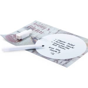A white Solek felt tip pen rests beside a circular notepad with handwritten notes on it, placed on a colourful menu background.