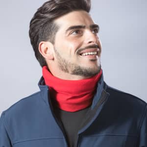 A red neck warmer worn by a man smiling, dressed in a navy jacket. The product has a logo.
