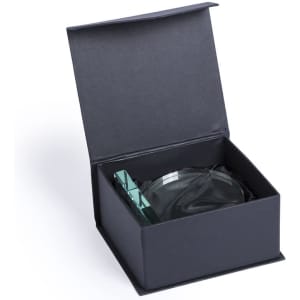 A green glass plaque resting inside a dark presentation box. The box has a hinged lid.