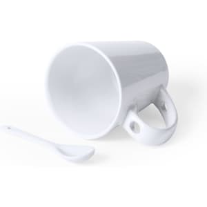 A white sublimation coffee mug with a matching spoon, featuring a smooth, curved design and a handle.