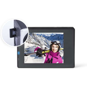 A black action camera with a display showing a skier in a snowy landscape. It has a logo on the side.