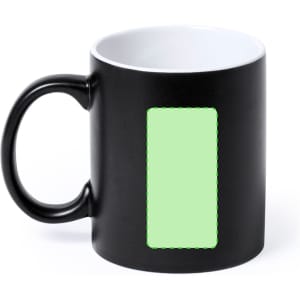 A coffee mug featuring a black exterior and white interior, with a blank green rectangle on the side.