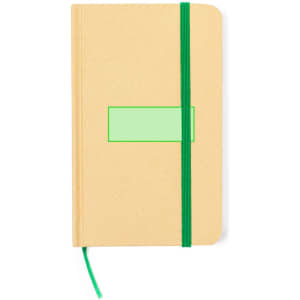 A kraft-coloured notepad with a green elastic band and a blank rectangular label on the cover.