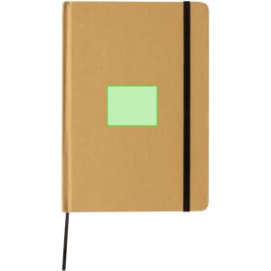 A tan notepad with a black elastic band, featuring a green square area on the front and an attached black ribbon marker.