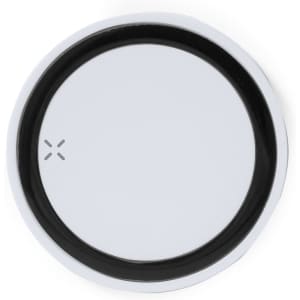A wireless charger with a circular design featuring a black border and a reflective silver centre, including a logo.