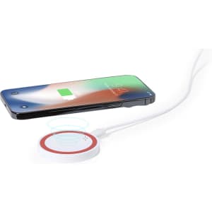 A wireless charger in white with a red circle, positioned beneath a smartphone displaying a charging indicator.
