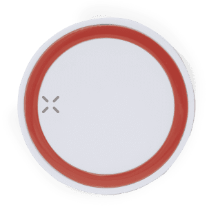 A wireless charger featuring a white surface with a red circular border and logo.