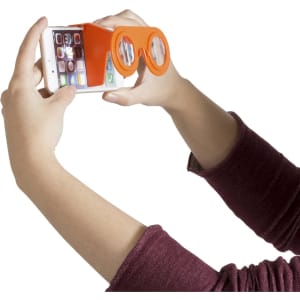 An orange virtual reality device attached to a smartphone, held by a person in a maroon sleeve.