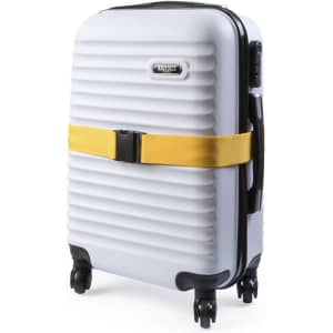 A suitcase in white with a yellow luggage strap, featuring a hard shell and wheels for mobility.