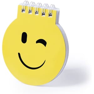 A yellow circular notebook with a smiling face design and a metal spiral binding.