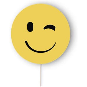A yellow round smiley face prop with a wink, mounted on a stick, featuring a simple black design.