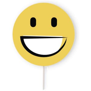 A round, yellow smiley face prop with a broad white smile and black features on a stick.