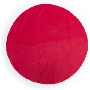 A round red beach mat with a fringed edge and a logo.