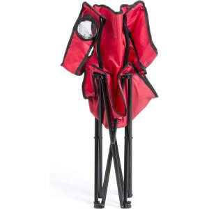 A red folding chair with black accents is displayed in a compact, upright position. It features a carrying handle.