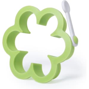 A flower-shaped green mould with a white handle, designed for food preparation.