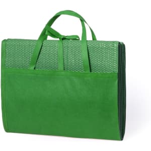 A green beach mat with a textured surface, featuring a carry handle and an exterior pocket.