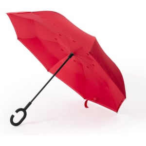 A red reversible umbrella with a black handle and curved grip. It features a sleek design and a branding logo.
