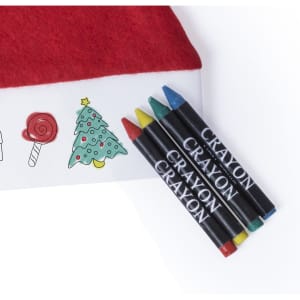 A red Christmas hat with a white base, alongside four colourful crayons: green, blue, red, and yellow.