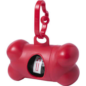 A red bone-shaped waste bag dispenser with a clip and a visible roll of bags inside.