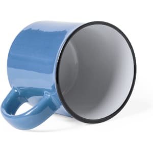 A blue ceramic coffee mug with a black rim and a handle, positioned on its side.